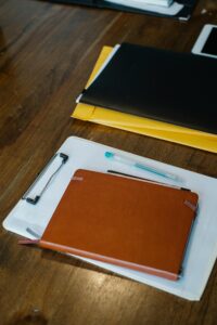Two clipboards with paper documents comparing the Rice Purity Test and the Innocence Test side by side